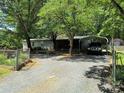 Cozy home with a carport, surrounded by mature trees on a spacious lot at 189 6Th Ave, New London, NC 28127