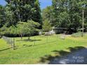 Large grassy yard enclosed by a chain-link fence, providing a safe and spacious area at 189 6Th Ave, New London, NC 28127
