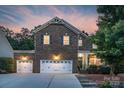 Charming brick home boasts a three-car garage, classic shutters, and a welcoming front porch at 1919 Madeira Cir, Waxhaw, NC 28173