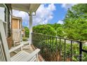 Relaxing front porch featuring white rocking chairs and a view of the surrounding greenery at 1919 Madeira Cir, Waxhaw, NC 28173