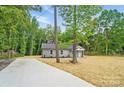 Attractive single-story home with gray exterior and a lengthy driveway surrounded by mature trees at 195 Linda St, Salisbury, NC 28146