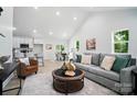 Bright and open living room featuring modern furniture, high ceilings, and a view into the kitchen and dining areas at 195 Linda St, Salisbury, NC 28146