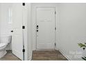 Clean entryway featuring a white door with a modern handle and a visible toilet at 2018 Crooked Oak Ln, York, SC 29745