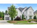 Beautiful two-story home with a lush lawn, an attached garage, and a well-manicured landscape at 2026 Thatcher Way, Fort Mill, SC 29715