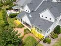 Aerial view showcases the home's meticulously landscaped backyard and outdoor living space with pool at 2026 Thatcher Way, Fort Mill, SC 29715
