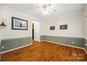Elegant living room with hardwood floors, wainscoting, and ample natural light at 220 Glenville Dr, Fort Mill, SC 29715