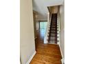 Inviting entryway showcasing hardwood floors and a carpeted staircase leading to the upper level at 303 Eastwood Dr, Salisbury, NC 28146