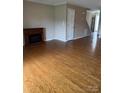 Open living area boasts hardwood floors and an electric fireplace at 303 Eastwood Dr, Salisbury, NC 28146