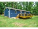 Rear exterior of house featuring deck with railings, perfect for outdoor relaxation at 327 Holly Dr, Mount Holly, NC 28120