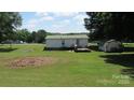 Backyard features a deck and a storage shed in a grassy yard at 338 Hickory Grove Rd, Harmony, NC 28634