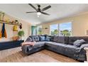 Comfortable living room with hardwood floors, a gray couch, a ceiling fan, and plenty of light at 338 Hickory Grove Rd, Harmony, NC 28634