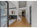 Grand foyer with hardwood floors, staircase with iron railings, and views of the living and dining areas at 389 Ponderosa Cir, Mooresville, NC 28117