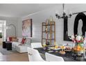 Elegant dining area with modern chandelier, stylish furnishings, and artistic wall decor at 4110 Lattistep Ln, Charlotte, NC 28269