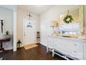 Bright foyer with dark hardwood floors, white console table, and decorative mirror at 4151 Green Park Ct, Harrisburg, NC 28075