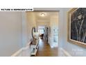 Elegant foyer features hardwood floors, decorative molding, console table, and a view leading to the bright living spaces at 505 York Rd, Troutman, NC 28166