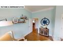 Stylish office showcases charming decor, ample shelving, and a cozy seating area, creating an inviting workspace at 505 York Rd, Troutman, NC 28166