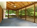 Spacious screened porch with wood lattice, perfect for outdoor relaxation and entertaining with wooded views at 52 September Ct, Concord, NC 28025