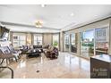 Spacious living room featuring marble floors, large windows, and comfortable seating area at 520 E Martin Luther King Jr Blvd # 1002, Charlotte, NC 28202