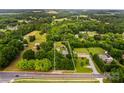 An aerial view shows the property lines surrounding the home on a large treed lot at 648 Odell School Rd, Concord, NC 28027
