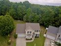 Aerial view of a two-story home surrounded by lush greenery and trees in a wooded area at 6608 Pattonsburg Dr, Charlotte, NC 28213
