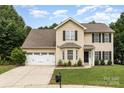 Charming two-story home featuring neutral siding, black shutters, and a well-manicured lawn at 6608 Pattonsburg Dr, Charlotte, NC 28213