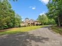 Beautiful exterior shot of home and manicured lawn with blue skies and scattered trees at 6742 Charlotte Hwy, York, SC 29745