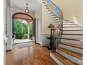 Open foyer featuring hardwood floors, a curved staircase, and elegant lighting at 6742 Charlotte Hwy, York, SC 29745