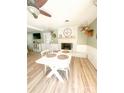 Bright dining room featuring hardwood floors, a white brick fireplace, and an abundance of natural light at 701 Bethlehem Church Rd, Kings Mountain, NC 28086