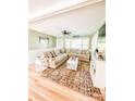Cozy living room with large sectional sofa, plush rug, hardwood floors and large windows at 701 Bethlehem Church Rd, Kings Mountain, NC 28086