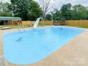 Large in-ground pool, surrounded by a patio and a fenced yard with play-set and shed at 701 Bethlehem Church Rd, Kings Mountain, NC 28086