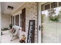 Inviting front porch featuring a cozy bench, brick accents, and a 'Welcome' sign at 9135 Stokes Ferry Rd, Salisbury, NC 28146