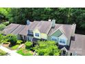 Aerial view of colorful townhomes with lush green trees in the background at 9216 Four Mile Creek Rd, Charlotte, NC 28277