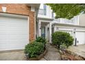 Charming home entrance with a blue front door, manicured bushes, and well-lit walkway at 10207 Garmoyle St, Charlotte, NC 28277