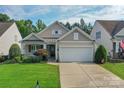 Attractive one-story home featuring a well-kept lawn, a two-car garage, and inviting curb appeal at 10405 Scotland Ave, Indian Land, SC 29707