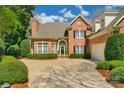 Lovely two-story brick home with manicured lawn, mature trees and welcoming curb appeal at 10508 Old Wayside Rd, Charlotte, NC 28277