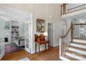 Elegant foyer featuring hardwood floors, staircase, and views into a sitting room at 10508 Old Wayside Rd, Charlotte, NC 28277