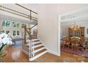Grand foyer with staircase leading to the second floor overlooking a living room and dining room at 10508 Old Wayside Rd, Charlotte, NC 28277