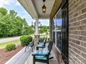 Cozy front porch featuring comfortable seating and views of the serene neighborhood at 10800 Alabaster Dr, Davidson, NC 28036