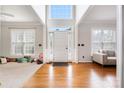 Inviting foyer with soaring ceilings, gleaming hardwood floors, and abundant natural light from large windows at 139 Forest Walk Way, Mooresville, NC 28115