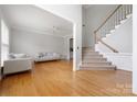 Bright living room featuring hardwood floors, neutral paint, and a staircase leading to upper level at 139 Forest Walk Way, Mooresville, NC 28115