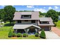Aerial view of a two-story home with a manicured lawn and charming covered front porch at 14701 Cabarrus Rd, Mint Hill, NC 28227