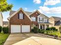 Lovely two-story brick home with three-car garage and mature landscaping at 1564 Trippett Nw St, Concord, NC 28027