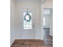 Bright foyer features dark wood-look floors, white wainscoting, and a glass-paneled front door at 1636 Red Leaf Dr, Fort Mill, SC 29715