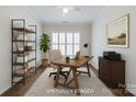 This staged office space features a light colored rug and shutters on the bright windows at 1636 Red Leaf Dr, Fort Mill, SC 29715