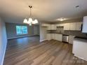 Bright kitchen featuring white cabinets, stainless steel appliances, and hardwood flooring at 1820 Wendover Dr, Lancaster, SC 29720