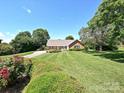 Spacious front yard with a brick home, mature trees, and a long driveway at 202 Cameron Dr, Kings Mountain, NC 28086