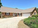 Beautiful brick home with a well-maintained driveway and lawn, complemented by lush landscaping at 202 Cameron Dr, Kings Mountain, NC 28086