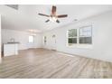 Open-concept living room boasts hardwood floors, natural light, and fresh, neutral paint at 314 Adams St, Salisbury, NC 28144