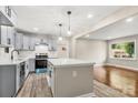 Modern kitchen boasts gray cabinetry, stainless steel appliances, white countertops and a functional kitchen island at 316 Fulton St, Kings Mountain, NC 28086