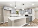 This kitchen features gray cabinets, stainless steel appliances, white countertops, and a central island at 316 Fulton St, Kings Mountain, NC 28086